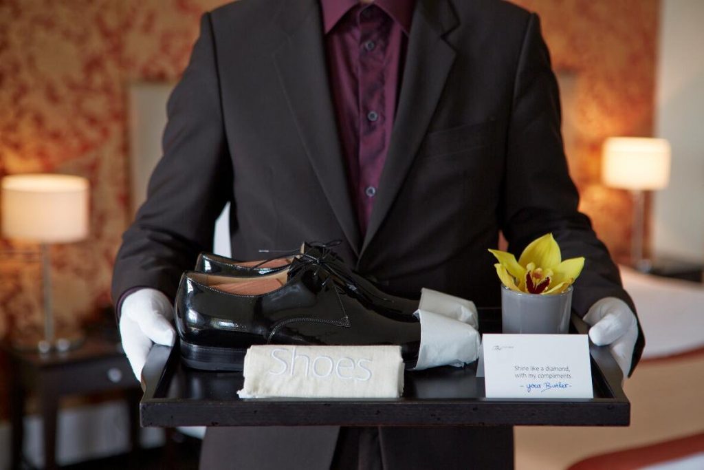 Butler service in a luxury hotel suites - butler with a polished shoes 
