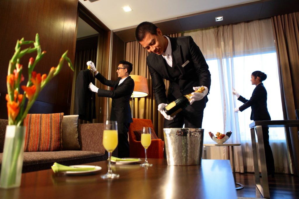 Three Butler working on a luxury hotel suite