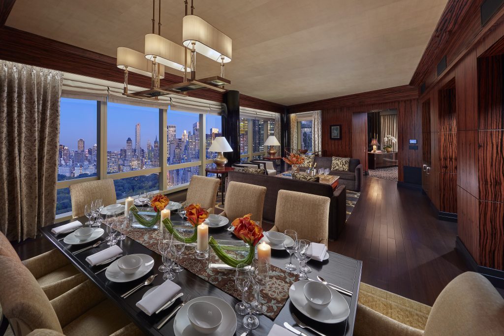 Huge luxury presidential suite living and dining room with New York City view