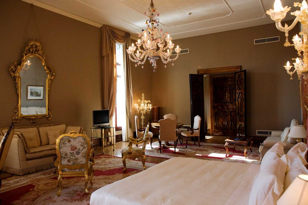 murano glass chandeliers and golden interior of luxury hotel suite Venice 