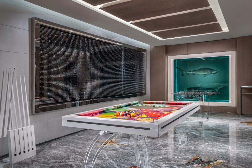 Colorful billiard tble and large Damien Hirst cabinet with full of pills and shark cabinet