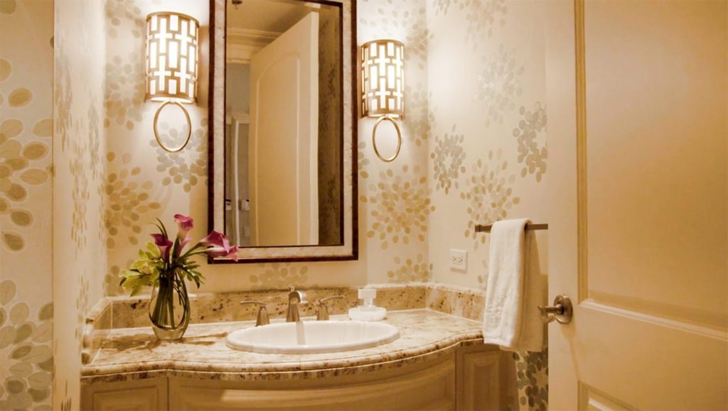 elegant small bathroom in the bellagio hotel suite with flowers and mirror