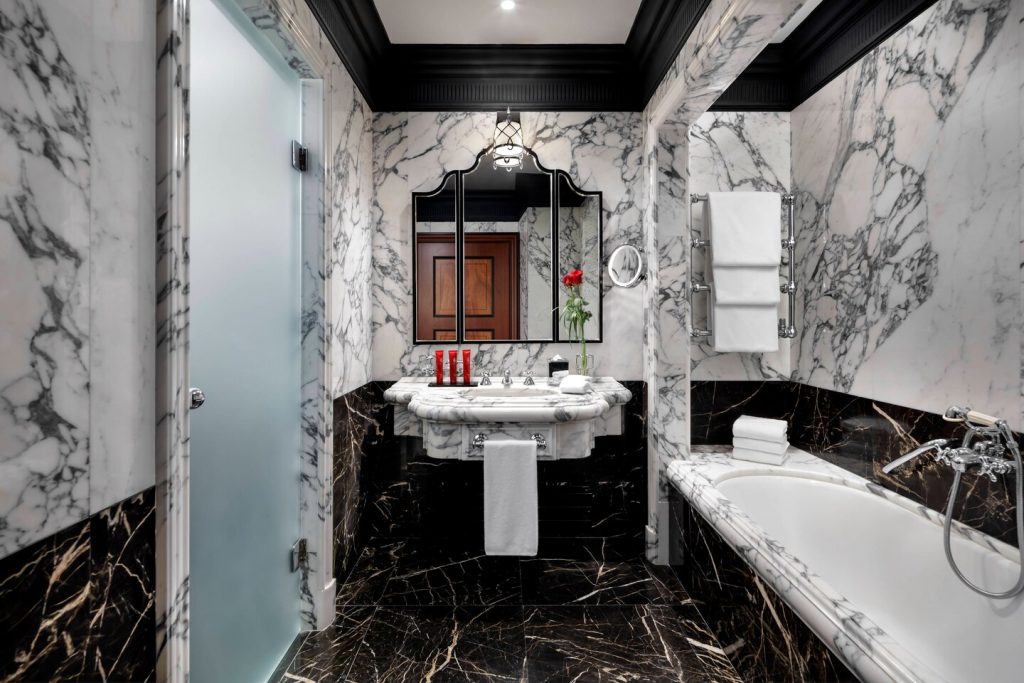black and white marble bathroom with bathtub and opal shower