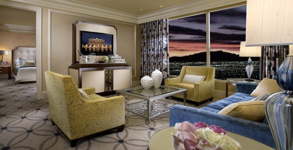 bellagio suite living room interior with armchairs and sofa and glass table and huge windows