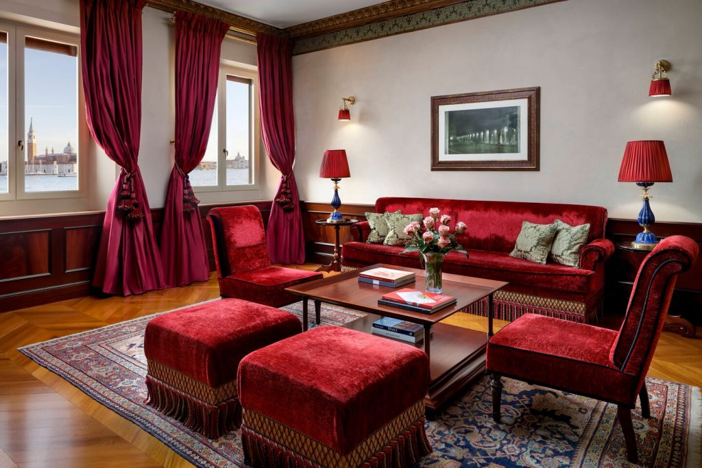 red furniture red sofa and red armchair in a luxury suite living room in Hotel Danieli with lagoon view