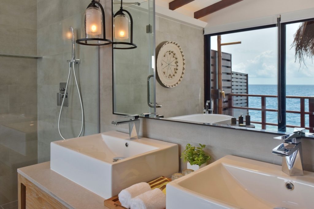 luxury bathroom with huge mirror double sanitary and ocean view