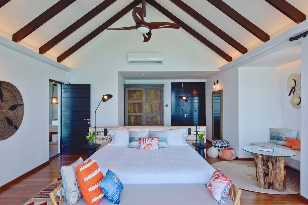 huge villa interior high ceiling with huge bed in the middle with white carpet